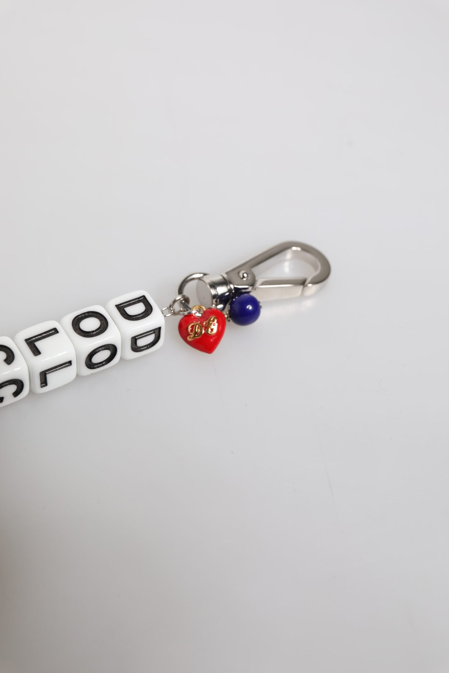 Bracciale Dolce & Gabbana con ciondolo decorato con logo a dadi e catena in ottone argentato