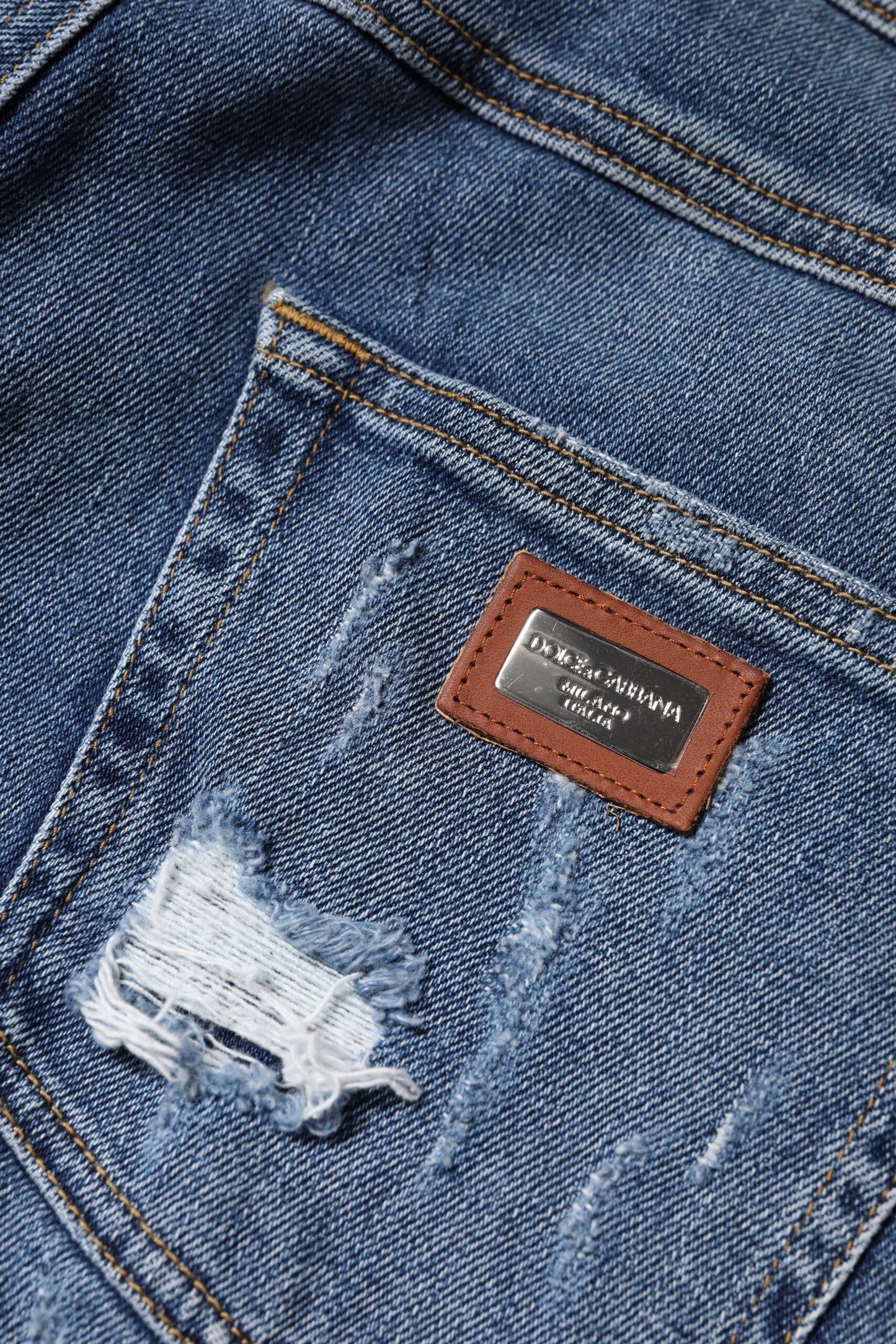 Jeans in denim a vita bassa in cotone blu strappato Dolce & Gabbana