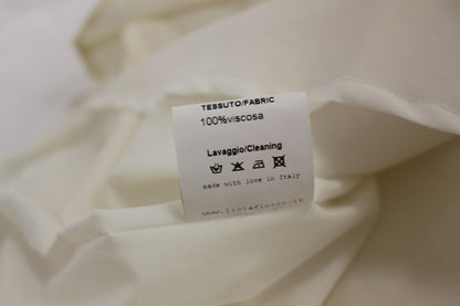 Abito da tè bianco con scollo all'americana e lunghezza al ginocchio di Licia Florio
