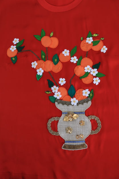Blusa in seta rossa con cristalli floreali e arance di Dolce &amp; Gabbana